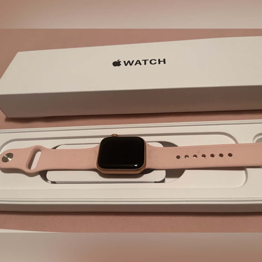 Apple watch in gold with pink strap